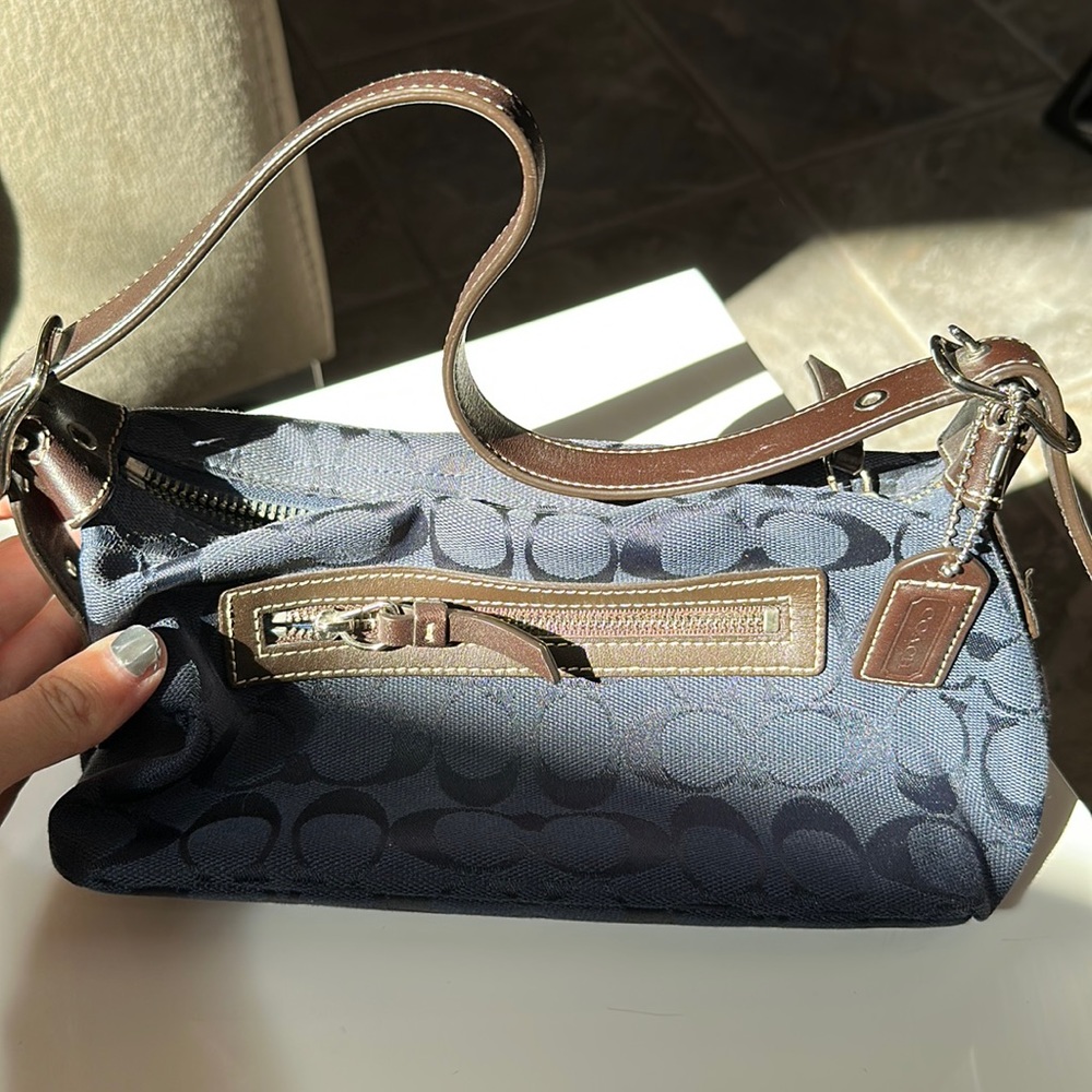 Navy blue Coach small bag. Can fit wallet, phone, makeup, and keys!